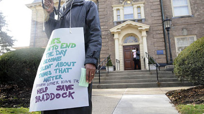 Rev. James McDonald, Jr., president of ther Greater Braddock Ministry Association and pastor for First Baptist Church of Braddock Hills, addresses approximately 50 protesters in front of University of Pittsburgh Chancellor Mark Nordenberg's residence in Oakland today in a rally against the closing of UPMC Braddock hospital.