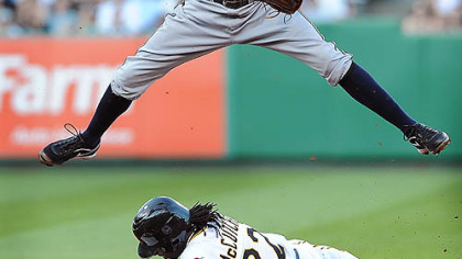 The Pirates' Andrew McCutchen is out at second base as Brewers shortstop Alcides Escobar relays a double-play throw Thursday at PNC Park.