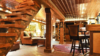 The basement is finished in the English tradition with sandstone walls and a brick floor. The steps were cut from timber that was salvaged from home's attic.