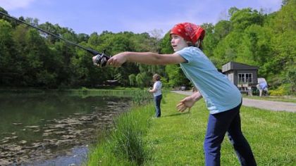 Genevieve Moffett, 6, practices casting off as she fishes for blue gill May 20 at a private lake in Bell Acres that is open to the Fern Hollow Nature Center. The Fern Hollow Nature Center in Sewickley was awarded a grant to develop a youth and family fishing program.