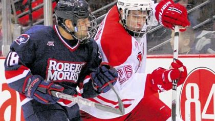 Robert Morris winger Ron Cramer battles with Miami defender Joe Hartman for the puck in the first period last night at Mellon Arena.
