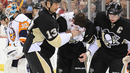 Penguins forwards Bill Guerin, left, and Sidney Crosby, right, help Pascal Dupuis off the ice after he was hit into the boards by Islanders defenseman Andy Sutton in the third period Tuesday. Sutton yesterday was suspended for two games.