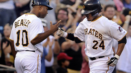 The Pirates' Delwyn Young is congratulated by third base coach Tony Beasley after hitting a three-run home run against the Brewers in the fourth inning of Wednesday's game at PNC Park.