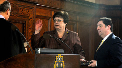 Newly elected City Council President Darlene Harris is sworn into office by District Judge James Motznik, a former City Council member, with a Bible held by William Peduto.