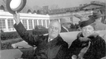 Franklin Delano Roosevelt and his wife Eleanor Roosevelt are seen in the back seat of an open limousine arriving at the White House in Washington following his inauguration in 1941.
