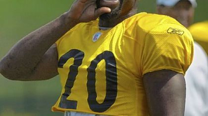 File photo of Bryant McFadden yells to a then-teammate while warming up at training camp. Draft trade action is bring him back to the Black and Gold.