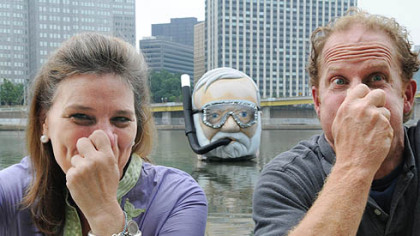 Marguerite Jarrett Marks, director of the Three Rivers Arts Festival,  and artist Stephen Antonson goofoff in front of his sculpture.