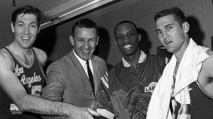 Los Angeles Lakers coach Fred Schaus, second from left, congratulates three Lakers, from left to right, Rudy LaRusso, Dick Barnett and Jerry West, after the team won the NBA Western Division playoffs in Baltimore on April 14, 1965.