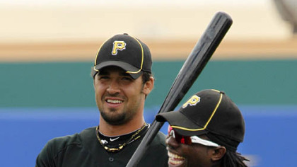 Pirates outfielders Garrett Jones, left, and Lastings Milledge warm up in the outfield.