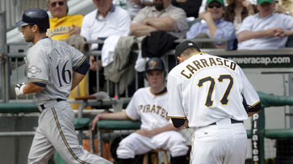 The Brewers' George Kottaras trots past Pirates reliever D.J. Carrasco after his leadoff home run in the fifth inning.