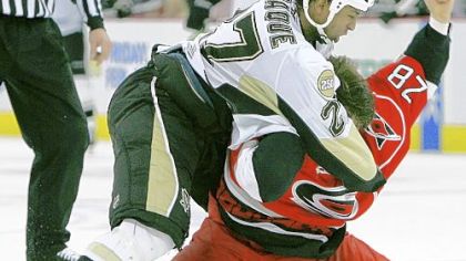The Carolina Hurricanes' Wade Brookbank (28) and former Penguin Georges Laraque fight during a 2008 game.