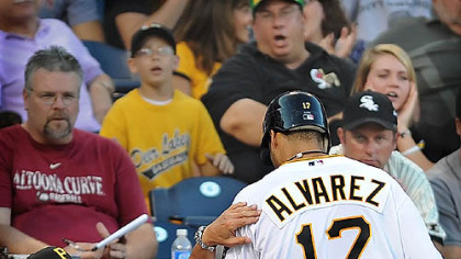 The Pirates' Pedro Alvarez is congratlated by manager John Russell after he scores the Pirates' only run in the fifth inning.