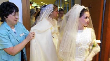 As part of "Weddings Through the Years," Mary Ann Migliorino, left, wedding coordinator for Christ United Methodist Church, with Kate Whitewood, who is wearing Mrs. Migliorino's wedding dress of July 24, 1971.