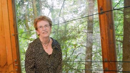 Artist Adrienne Heinrich poses next to her work "Art Lives."