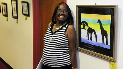 Linda Franklin, with her watercolor "Giraffes At Dusk," at the 23rd annual Flowering of Insight art exhibit.