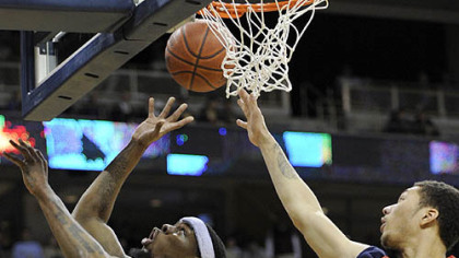 Pitt forward Nasir Robinson gets a shot up against Robert Morris forward Dallas Green in the second half.