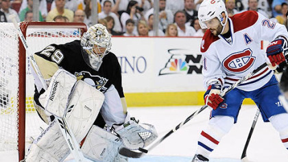 Canadiens forward Brian Gionta attempts to redirect a puck as Penguins goaltender Marc-Andre Fleury defends the net during Sunday's at Mellon Arena.