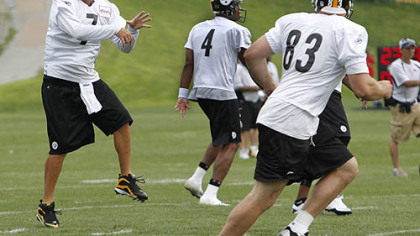 Steelers quarterback Ben Roethlisberger passes to tight end Heath Miller  during the first practice session at the NFL football team's training camp in Latrobe on Saturday.