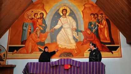 Mother Alexandra and Father Anthony Yazge with the huge resurrection icon at Antiochian Village outside Ligonier.