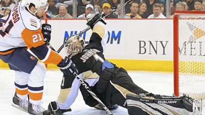 Penguins goaltender Brent Johnson stops Islanders forward Kyle Okposo on a penalty shot in the second period.