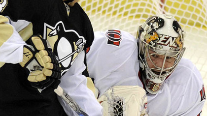 Senators goaltender Brian Elliott stops a shot in front of Penguins defenseman Alex Goligoski in the second period of Wednesday's game at Mellon Arena.