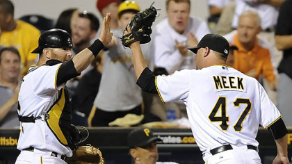 Pirates pitcher Evan Meek high fives catcher Ryan Doumit during last night's game at PNC Park.