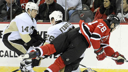 Martin Skoula, who the Penguins traded away at the deadline, is checked by Penguins' Ruslan Fedotenko as Chris Kunitz (14) looks on during the first period Friday night. The Penguins traded Skoula to Toronto, who then turned around and dealt him to New Jersey a day later.