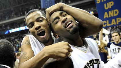 Pitt guard Jermaine Dixon hugs exhausted guard Brad Wanamaker after defeating West Virginia in triple overtime at the Petersen Events Center Friday.