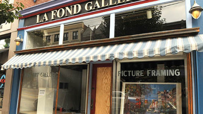 A sheet of plywood covers the front door of La Fond Galleries, on the South Side. A Pitt football player allegedly threw a man through this door.