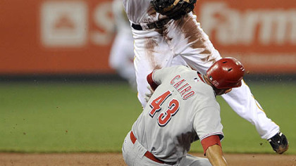 Pirates second baseman Neil Walker gets Reds Miguel Cairo out at second base on a double play in the first inning.