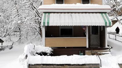 Matching patio chairs save a shoveled parking space along Lorenz Avenue in Sheraden.