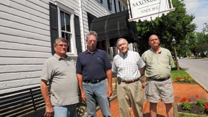 From left, Chuck Matus, JRHSS Design Community; Ray Rush, Main Street Program manager; Dennis Chambers, chairman of Saxonburg Historical and Restoration Commission; and Gary Mullen, member of Saxonburg Historical and Restoration Commission outside the Hotel Saxonburg.