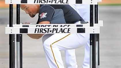 Pirates pitcher Craig Hansen watches Tyler Yates do rehab drills Monday in Bradenton, Fla.