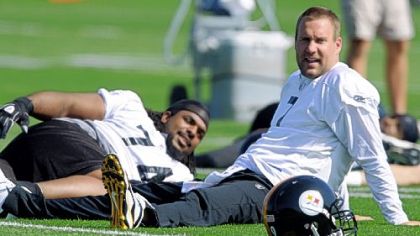 Pittsburgh Steelers quarterback Ben Roethlisberger stretches with tackle Willie Colon before the first day of mandatory off-season workouts.