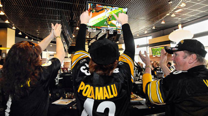 Steelers fans at Jerome Bettis' Grille 36 on the North Shore: From left, Pam Stewart of Freeport; Jennine Kasperoski of Mount Oliver, and Les Jarvis of St. Clairsville, Ohio. They're cheering Heath Miller's third-quarter touchdown.