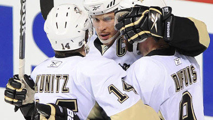 Penguins forward Sidney Crosby celebrates a goal with teammates Chris Kunitz and Pascal Dupuis during Monday's game at the Bell Centre.