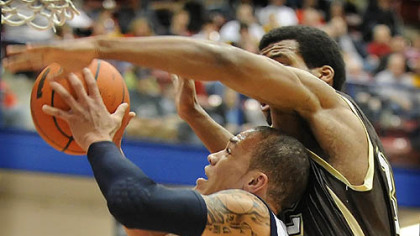 Duquesne's Bill Clark goes up against St. Bonaventure's Michael Davenport.