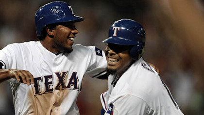 Rangers Elvis Andrus, left, celebrates with teammate Nelson Cruz after scoring the winning run.
