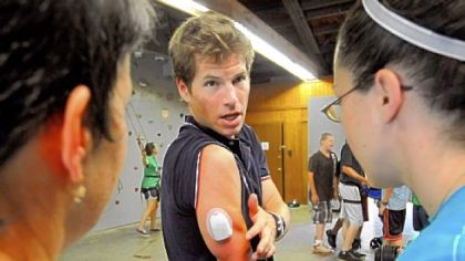 Olympic cross-country skier Kris Freeman, who has type 1 diabetes, explains the insulin pump on his arm during his visit to the American Diabetes Association's Camp Diabetes at Camp Crestfield in Slippery Rock.