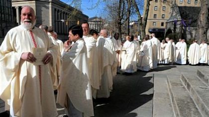 Priests wait for the start of the Processional for The Mass of Chrism at St. Paul Cathedral in Oakland.