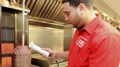 Ebraheim Salem cuts fresh-cooked lamb for gyros for a lunch order at Salem's Market & Grill in the Strip District.