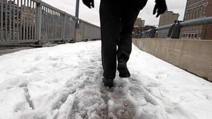 A man walks on Monday on a sidewalk near Grant Street, Downtown, at the end of the Eliza Furnace section of the Three Rivers Heritage Trail.