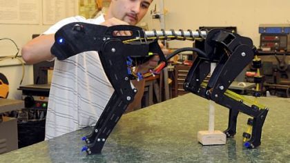 Daniel Shope, a senior studying mechanical and biomedical engineering at Carnegie Mellon University, works on his Cheebot robot prototype. He's seeking Kickstarter funding for the project.