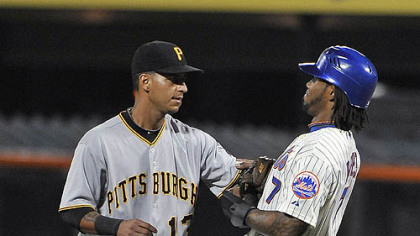 The Mets' Jose Reyes is tagged out by Pirates shortstop Ronny Cedeno, caught stealing between first and second bases in the first inning.