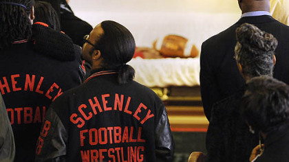 Students from the Schenley High School sports teams file past Jeron Grayson's casket at Wesley Center AME Zion Church.
