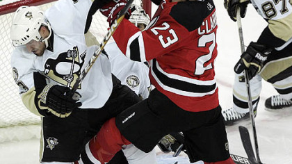 Devils forward David Clarkson Penguins defenseman Alex Goligoski out of the crease as Penguins goaltender Brent Johnson looks for the puck in the second period.