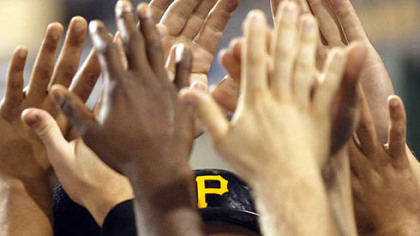 The Pirates' Garrett Jones returns to the dugout after he scored in the third inning Wednesday at PNC Park.