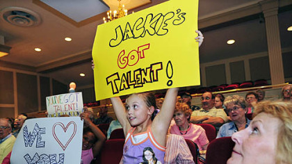 Kathrine Kelly, 8, holds up her sign at the Kean Theater at St. Barnabas in Gibsonia where well wishers gathered to watch Jackie Evancho on "America's Got Talent."