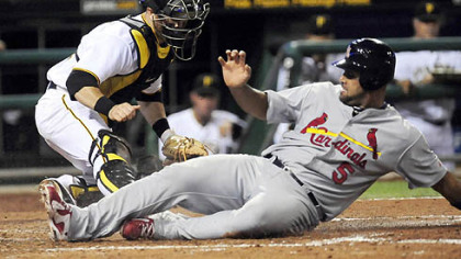 Pirates catcher Ryan Doumit is too late with the tag on the Cardinals' Albert Pujois hustling home from second base in the fifth inning Monday at PNC Park.