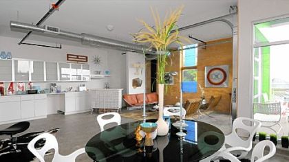 Bernie Schilling of Mostly Mod furnished this unit in the Glass Lofts with a glass-topped Chromecraft table and Oh! chairs by British designer Karim Rashid.